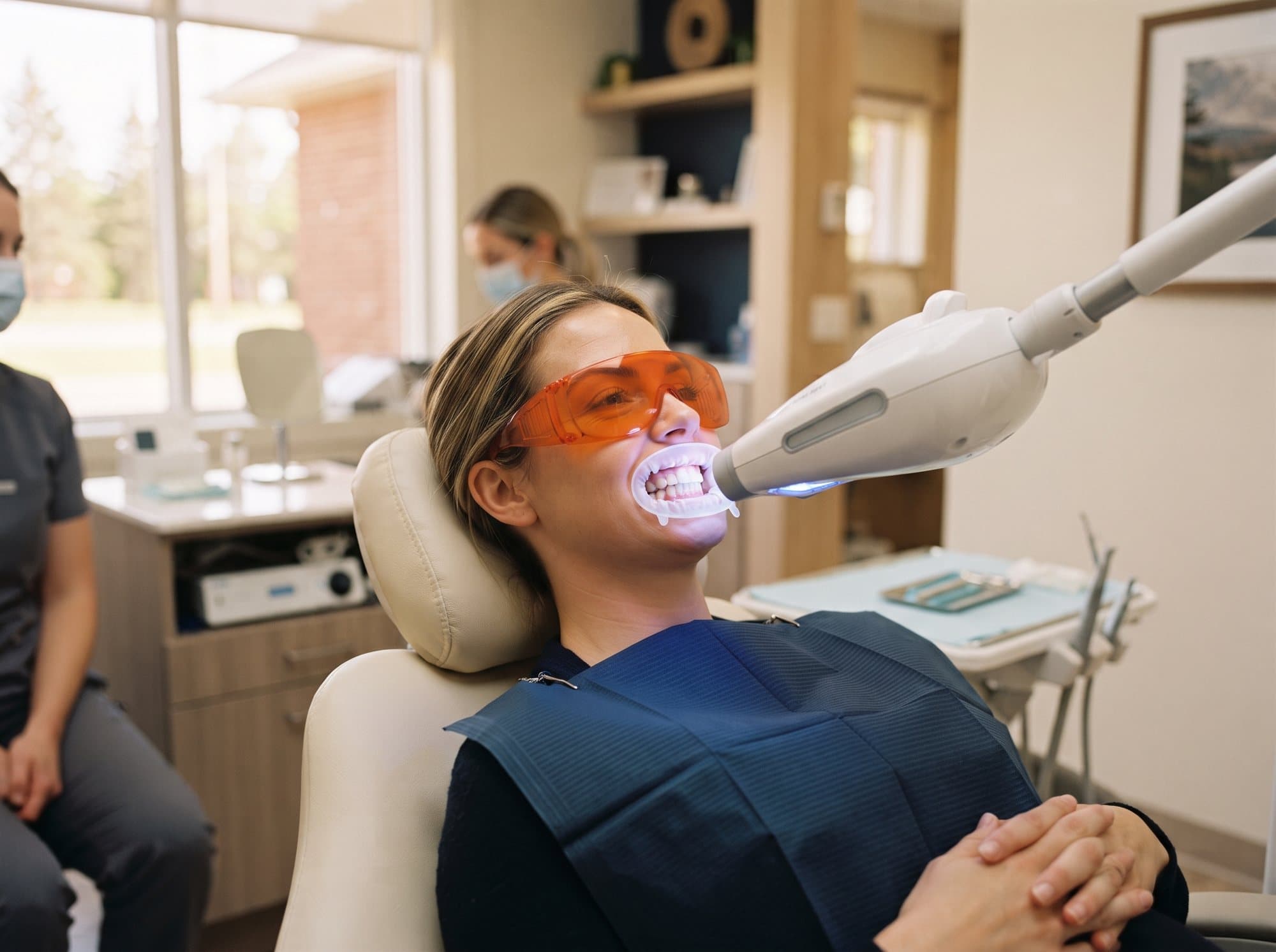 A patient receiving Zoom!® in-office whitening under the lamp at Riverside West Dental